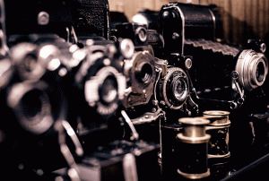 old cameras lined up, with focus on one