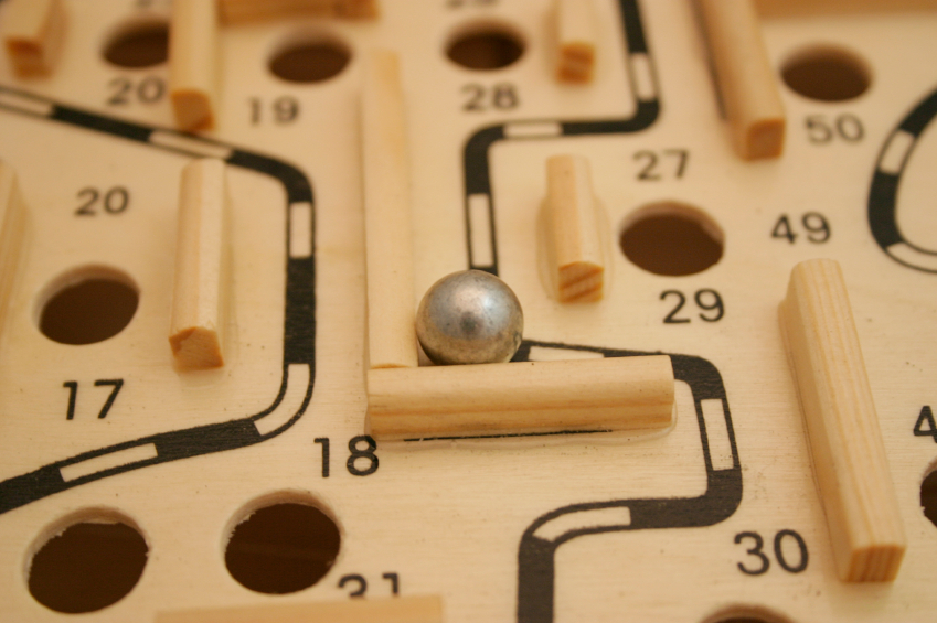 Maze puzzle with metal ball and obstacles
