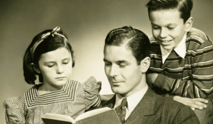father and his two children reading