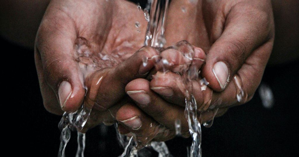 Hands under a stream of running water